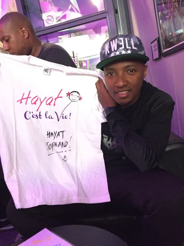 Le chanteur Soprano montre le t-shirt Hayat c'est la vie